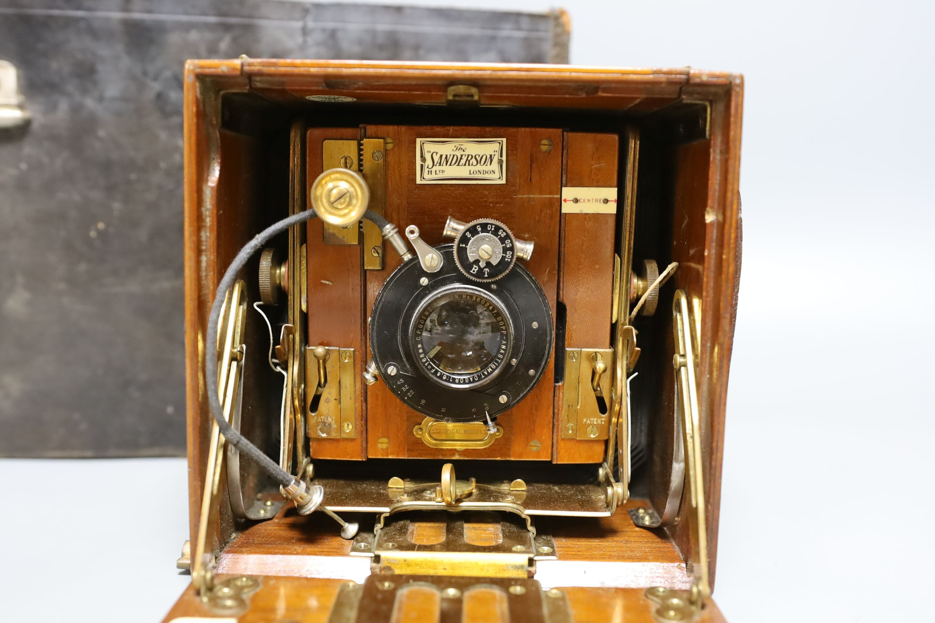 A Sanderson ‘Tropical Model’ plate camera, leather cased with various mahogany plate holders.